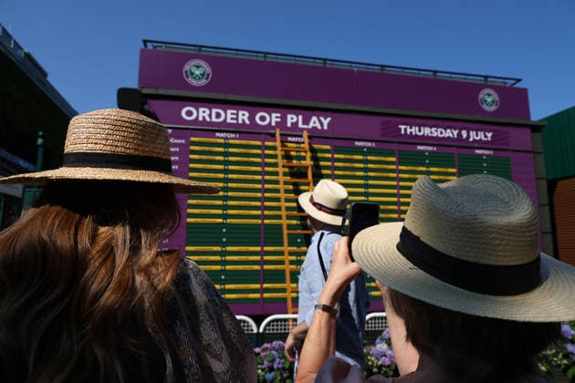 RECORD DATE NOT STATED 9th July 2026; All England Lawn Tennis and Croquet Club, London, England; Wimbledon Tennis Tournament, Day Eleven; Spectators taking pictures of the Order of Play as they arrive at Wimbledon JohnxPatrickxFletcher