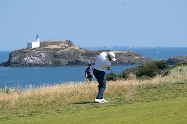 UK: The Genesis Scottish Open at The Renaissance Club, North Berwick, Scotland on 09 July 2026: Pictured: Wyndham Clark (USA) on the 4th fairway with Fidra Island and lighthouse in the background during the first round of the Genesis Scottish Open Championship 2026 North Berwick The Renaissance Club Scotland Scotland Copyright: xAlexxToddx