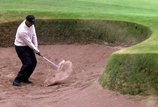 GOLF-WOODS GOLF-WOODS CAR13 - 19990713 - CARNOUSTIE, UNITED KINGDOM : US golfer Tiger Woods plays out of a bunker at the 5th green, 13 July 1999, during his official practise round for the 128th Open Golf Championship at Carnoustie starting Thursday 15 July. (ELECTRONIC IMAGE) Carnoustie United Kingdom  Copyright: xGerryxPennyx