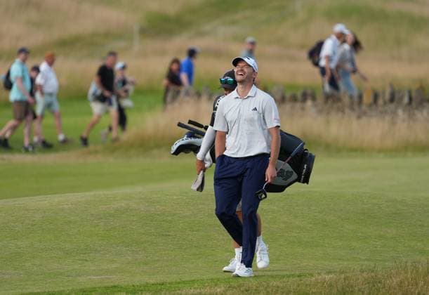 Rasmus Hojgaard of Denmark laughs with his caddie as he walks on to the 18th green. Genesis Scottish Open, Golf, The Renaissance Club, North Berwick, Scotland, UK - 09 Jul 2026North Berwick The Renaissance Club Scotland United Kingdom  Copyright: xShutterstockx 16984080dw
