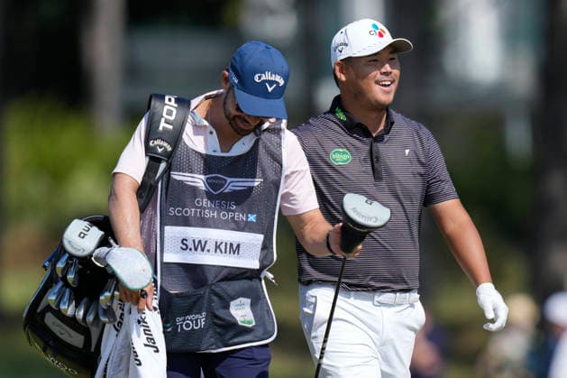 NORTH BERWICK, SCOTLAND - JULY 9: Si Woo Kim hold jokes with his caddie as he walks down the 7th hole during Round 1 of the Genesis Scottish Open at the Renaissance Club, North Berwick on July 9, 2026 in North Berwick, Scotland Genesis Scottish Open Round 1
