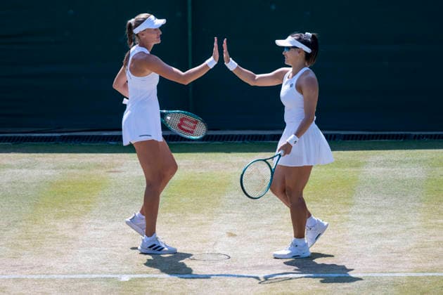 (260710) -- LONDON, July 10, 2026 -- Guo Hanyu (R) Kristina Mladenovic react during the women s doubles quarterfinal match between Katerina Siniakova (the Czech Republic) Taylor Townsend (the United States of America) and Guo Hanyu (China) Kristina Mladenovic (France) at the Wimbledon Tennis Championships in London, Britain, on July 9, 2026. (Photo by Xinhua) (SP)BRITAIN-LONDON-TENNIS-WIMBLEDON-WOMEN S DOUBLES StephenxChung 