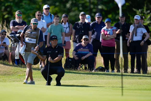 NORTH BERWICK, SCOTLAND - JULY 10: Patrick Reed passes his ball to his caddie on the 10th green during Round 2 of the Genesis Scottish Open at the Renaissance Club, North Berwick on July 10, 2026 in North Berwick, Scotland Genesis Scottish Open Round 2