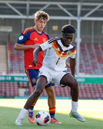 Wrexham, Wales, 11th July 2026. Boris Mamuzah Lum of Germany holds off a challenge from Thiago Pitarch of Spain during the Spain U19 vs Germany U19 UEFA European U19 Championship Final match at The Racecourse, Wrexham. Picture credit should read: Cody Froggatt Sportimage EDITORIAL USE ONLY. No use with unauthorised audio, video, data, fixture lists, club league logos or live services. Online in-match use limited to 120 images, no video emulation. No use in betting, games or single club league player publications. SPI_022_CF_SPAIN_U19_V_GERMANY_U19_FINAL SPI-4858-0022