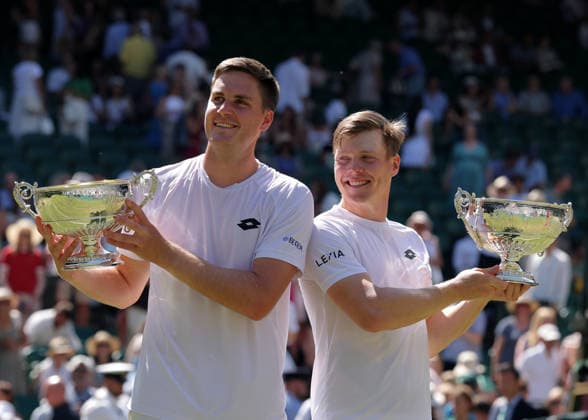 RECORD DATE NOT STATED 10th July 2026; All England Lawn Tennis and Croquet Club, London, England; Wimbledon Tennis Tournament, Day Twelve; Harri Heliovaara (FIN) and doubles partner Henry Patten (GBR) pose with their Gentlemen& x2019;s Doubles Trophies JohnxPatrickxFletcher