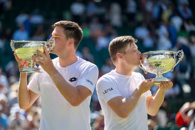 (260712) -- LONDON, July 12, 2026 -- Harri Heliovaara (R) Henry Patten kiss their trophies after winning the men s doubles final match between Harri Heliovaara (Finland) Henry Patten (Britain) and Marcelo Arevalo (El Salvador) Mate Pavic (Croatia) at the Wimbledon Tennis Championships in London, Britain, on July 11, 2026. (Photo by Xinhua) (SP)BRITAIN-LONDON-TENNIS-WIMBLEDON-MEN S DOUBLES StephenxChung 