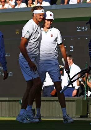 Alexander Zverev is helped to his feet by Jannik Sinner after slipping during the Men s Singles final Wimbledon Tennis Championships, Day 14, The All England Lawn Tennis and Croquet Club, London, UK - 12 Jul 2026London The All England Lawn Tennis and United Kingdom  Copyright: xJamesxMarsh Shutterstockx 16981035go