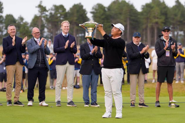 NORTH BERWICK, SCOTLAND - JULY 12: Tom Kim lifts the trophy on the 18th green after winning the Genesis Scottish Open at the Renaissance Club, North Berwick on July 12, 2026 in North Berwick, Scotland Genesis Scottish Open Round 4