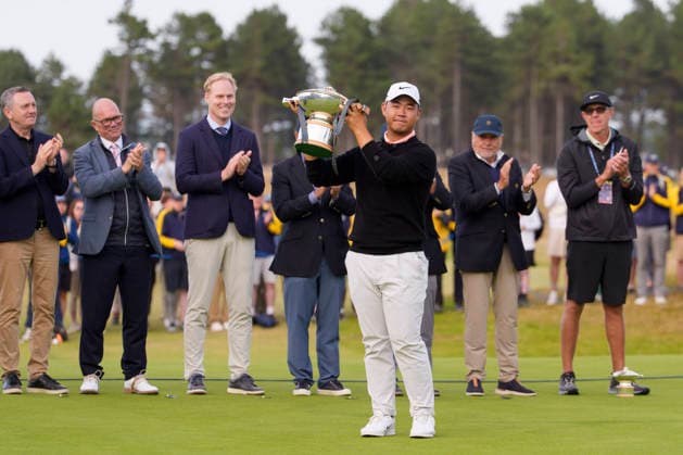 NORTH BERWICK, SCOTLAND - JULY 12: Tom Kim lifts the trophy on the 18th green after winning the Genesis Scottish Open at the Renaissance Club, North Berwick on July 12, 2026 in North Berwick, Scotland Genesis Scottish Open Round 4