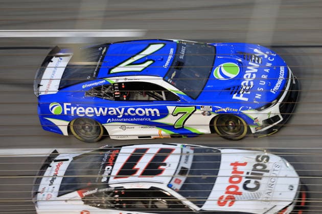 ATLANTA, GA - JULY 12: Daniel Suarez ( 7 Spire Motorsports Freeway Insurance Chevrolet) races with Denny Hamlin ( 11 Joe Gibbs Racing Clips Haircuts Toyota) into the tri-oval during the running of the NASCAR, Motorsport, USA Cup Series Quaker State 400 on July 12, 2026 at EchoPark Speedway in Hampton, GA. (Photo by Jeff Robinson Icon Sportswire) AUTO: JUL 12 NASCAR Cup Series Quaker State 400 EDITORIAL USE ONLY Icon26071213579400