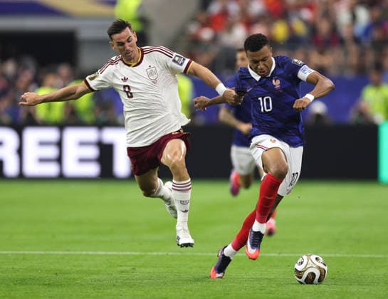 (260715) -- DALLAS, July 15, 2026 -- Kylian Mbappe (R) of France vies with Fabian Ruiz of Spain during the semifinal match between France and Spain at the 2026 FIFA World Cup, WM, Weltmeisterschaft, Fussball at Dallas Stadium in Dallas, the United States, July 14, 2026. ) (SP)U.S.-DALLAS-FOOTBALL-FIFA WORLD CUP-SEMIFINAL-FRA VS ESP XuxZijian 