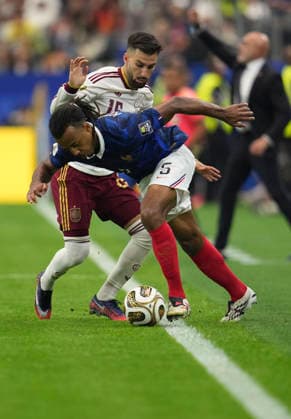(260715) -- DALLAS, July 15, 2026 -- Jules Kounde (front) of France vies with Alex Baena of Spain during the semifinal match between France and Spain at the 2026 FIFA World Cup, WM, Weltmeisterschaft, Fussball at Dallas Stadium in Dallas, the United States, July 14, 2026. ) (SP)U.S.-DALLAS-FOOTBALL-FIFA WORLD CUP-SEMIFINAL-FRA VS ESP WuxXiaoling 