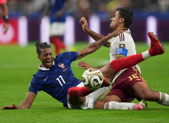 (260715) -- DALLAS, July 15, 2026 -- Michael Olise (L) of France falls down during the semifinal match between France and Spain at the 2026 FIFA World Cup, WM, Weltmeisterschaft, Fussball at Dallas Stadium in Dallas, the United States, July 14, 2026. ) (SP)U.S.-DALLAS-FOOTBALL-FIFA WORLD CUP-SEMIFINAL-FRA VS ESP WuxXiaoling 