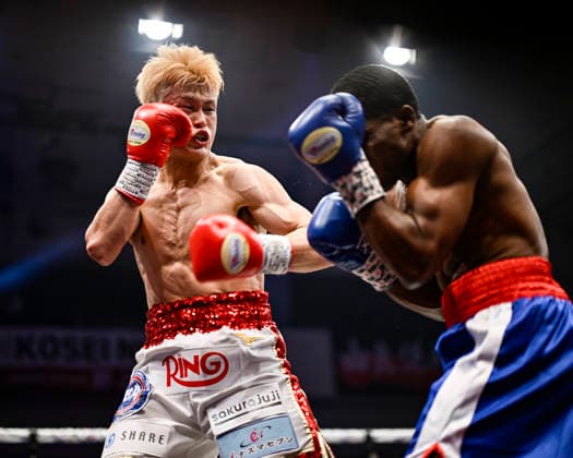 Hayato Tsutsumi (red gloves) of Japan and Felix Batista (blue gloves) of Dominican Republic compete during their WBA Super Featherweight Title Eliminator boxing bout at Korakuen Hall in Tokyo, Japan, July 14, 2026. Noxthirdxpartyxsales  aflo_338074470 HIROAKIxFINITOxYAMAGUCHIx