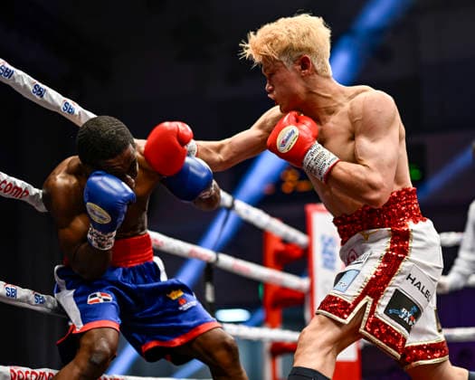 Hayato Tsutsumi (red gloves) of Japan and Felix Batista (blue gloves) of Dominican Republic compete during their WBA Super Featherweight Title Eliminator boxing bout at Korakuen Hall in Tokyo, Japan, July 14, 2026. Noxthirdxpartyxsales  aflo_338074473 HIROAKIxFINITOxYAMAGUCHIx