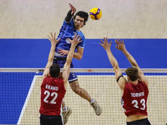 Men s Volleyball Nations League - Belgrade 2026 Slovenia s Nik Mujanovic spikes the ball against Germany s Tobias Brand and Germany s Simon Valentin Torwie during the MenÕs Volleyball Nations League Pool 7 match between Germany and Slovenia at Belgrade Arena on July 15, 2026 in Belgrade, Serbia. Belgrade Serbia Copyright: xSrdjanxStevanovicx x