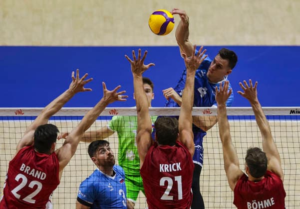 Men s Volleyball Nations League - Belgrade 2026 Slovenia s Jan Kozamernik spikes the ball against Germany s Tobias Brand, Germany s Tobias Krick and Germany s Yann Bohme during the MenÕs Volleyball Nations League Pool 7 match between Germany and Slovenia at Belgrade Arena on July 15, 2026 in Belgrade, Serbia. Belgrade Serbia Copyright: xSrdjanxStevanovicx x
