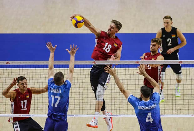 Men s Volleyball Nations League - Belgrade 2026 Germany s Florian Krage-Brewitz (C) spikes the ball against Slovenia s Tine Urnaut (L) and Slovenia s Jan Kozamernik during the MenÕs Volleyball Nations League Pool 7 match between Germany and Slovenia at Belgrade Arena on July 15, 2026 in Belgrade, Serbia. Belgrade Serbia Copyright: xSrdjanxStevanovicx x