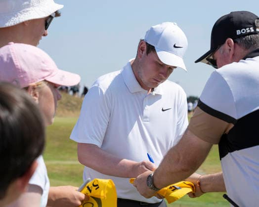SOUTHPORT, ENGLAND - JULY 15: Robert Macintyre (SCO) signs an autograph for a fan during practice at the 154th Open Championship at the Royal Birkdale Golf Club, Southport on July 15, 2026 in Merseyside, England The 154th British Open Championship
