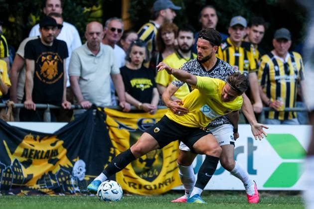 LOENEN , 15-07-2026 , Sportpark Lonapark , season 2026 2027 , Dutch pre-season football , friendly match between Vitesse and AEK Athens , picture shows AEK Athens player Dimitris Kaloskamis is challenged by Vitesse player Marco Schikora Vitesse - AEK Athens  x205043500x Copyright: