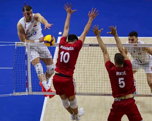 Men s Volleyball Nations League - Belgrade 2026 Serbia s Veljko Masulovic spikes the ball against Turkey s Mirza Lagumdzija and Turkey s Marko Matic during the MenÕs Volleyball Nations League Pool 7 match between Serbia and Turkiye at Belgrade Arena on July 15, 2026 in Belgrade, Serbia. Belgrade Serbia Copyright: xSrdjanxStevanovicx x