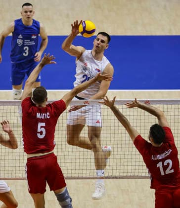 Men s Volleyball Nations League - Belgrade 2026 Serbia s Aleksandar Nedeljkovic spikes the ball against Turkey s Marko Matic and Turkey s Adis Lagumdzija during the MenÕs Volleyball Nations League Pool 7 match between Serbia and Turkiye at Belgrade Arena on July 15, 2026 in Belgrade, Serbia. Belgrade Serbia Copyright: xSrdjanxStevanovicx x