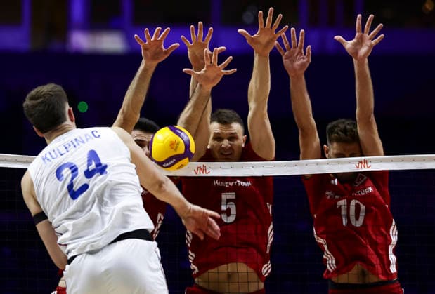 Men s Volleyball Nations League - Belgrade 2026 Serbia s Vuk Kulpinac spikes the ball against Turkey s Marko Matic (C) and Turkey s Mirza Lagumdzija (R) during the MenÕs Volleyball Nations League Pool 7 match between Serbia and Turkiye at Belgrade Arena on July 15, 2026 in Belgrade, Serbia. Belgrade Serbia Copyright: xSrdjanxStevanovicx x