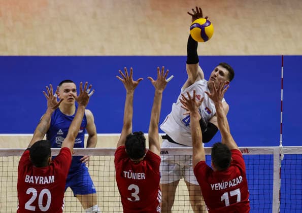 Men s Volleyball Nations League - Belgrade 2026 Serbia s Lazar Marinovic spikes the ball against Turkey s Efe Bayram, Turkey s Ahmet Tumer and Turkey s Murat Yenipazar during the MenÕs Volleyball Nations League Pool 7 match between Serbia and Turkiye at Belgrade Arena on July 15, 2026 in Belgrade, Serbia. Belgrade Serbia Copyright: xSrdjanxStevanovicx x