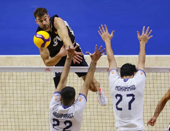 WomenÕs Volleyball Nations League - Belgrade 2026 Germany s Yann Bohme spikes the ball against IranÕs Ali Haghparast and IranÕs Mohammad Valizadeh during the MenÕs Volleyball Nations League Pool 7 match between Germany and Iran at Belgrade Arena on July 16, 2026 in Belgrade, Serbia. Belgrade Serbia Copyright: xSrdjanxStevanovicx x