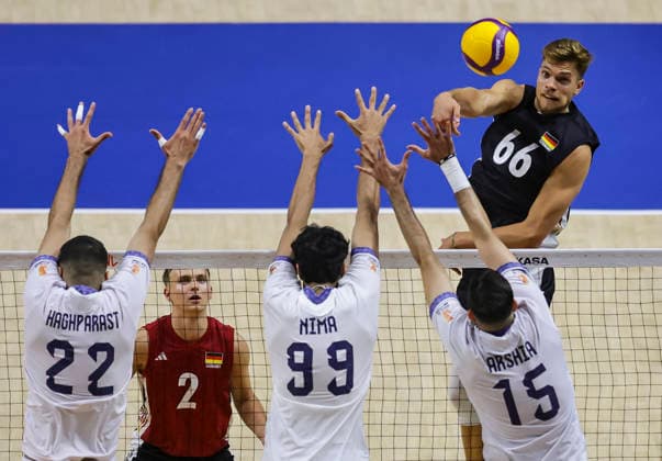 WomenÕs Volleyball Nations League - Belgrade 2026 Germany s Erik Rohrs spikes the ball against IranÕs Ali Haghparast (L) IranÕs Mohammadnima Bateni and IranÕs Arshia Behnezhad during the MenÕs Volleyball Nations League Pool 7 match between Germany and Iran at Belgrade Arena on July 16, 2026 in Belgrade, Serbia. Belgrade Serbia Copyright: xSrdjanxStevanovicx x