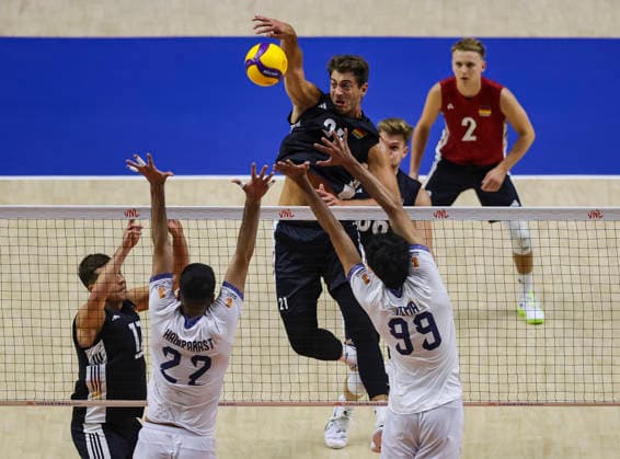 WomenÕs Volleyball Nations League - Belgrade 2026 Germany s Tobias Krick spikes the ball against IranÕs Mohammadnima Bateni and IranÕs Ali Haghparast (L) during the MenÕs Volleyball Nations League Pool 7 match between Germany and Iran at Belgrade Arena on July 16, 2026 in Belgrade, Serbia. Belgrade Serbia Copyright: xSrdjanxStevanovicx x