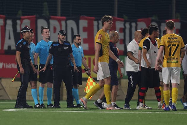 UEFA appointed match referee Jeremy Muller and his assistant referees stand between Malta Police Officers after awarding a late controversial penalty to Runavik during the UEFA Conference League First Qualifying Round, 2nd Leg match between Hamrun Spartans and Runavik at Centenary Stadium, Ta Qali, Malta on 16 July, 2026. Hamrun Spartans v Runavik - UEFA Conference League First Qualifying Round 1st Leg
