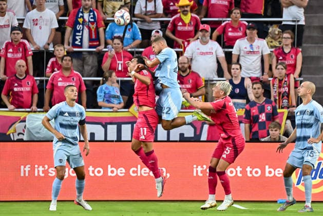 ST. LOUIS, MO - JULY 16: Simon Becher (11) of the St. Louis CITY SC gets bumped from behind by the jumping Zorhan Bassong (22) of the Sporting Kansas City during the MLS, Fussball Herren, USA regular season match where St. Louis CITY SC hosted Sporting Kansas City on Thursday July 16th, 2026, at Energizer Park in St. Louis City, MO. (Photo by Rick Ulreich Icon Sportswire) SOCCER: JUL 16 MLS St. Louis CITY SC vs Sporting Kansas City EDITORIAL USE ONLY Icon26071612