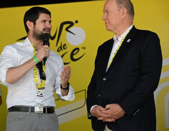 Départ 13e étape du tour de France, Dole, 17 juillet PHOTOPQR LE PROGRES Philippe TRIAS - 17 07 2026 - Départ 13e étape du tour de France, Dole, 17 juillet -Départ de la 13e étape du Tour de France dans la ville de Dole. Ambiance de la caravane qui passe sur fond de la collégiale et le départ fictif des coureurs avenue de Lahr. Le prince Albert II de Monaco était au départ de cette 13e étape, ici avec Jean-Baptiste Gagnoux, maire de Dole. - CYCLING TOUR DE FRANCE STAGE 13 JULY 17 2026 Jura Franche-Comté France  Copyright: xPHOTOPQR LExPROGRES MAXPPPxPhilippexTRIASx 20260717LPL4447 20260717LPL4447