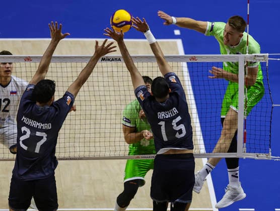 WomenÕs Volleyball Nations League - Belgrade 2026 Slovenia s Rok Mozic spikes the ball against IranÕs Arshia Behnezhad and IranÕs Mohammad Valizadeh during the MenÕs Volleyball Nations League Pool 7 match between Iran and Slovenia at Belgrade Arena on July 17, 2026 in Belgrade, Serbia. Belgrade Serbia Copyright: xSrdjanxStevanovicx x
