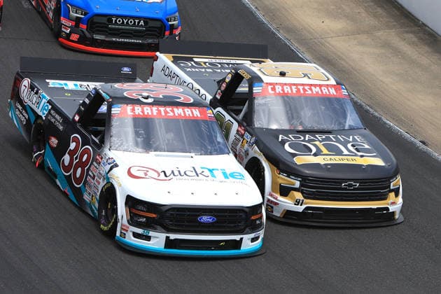 NORTH WILKESBORO, NC - JULY 18: Chandler Smith ( 38 Front Row Motorsports QuickTie Ford) races with Christian Eckes ( 91 McAnally Hilgermann Racing Adaptive One Calipers Chevrolet) into turn 4 during the running of the NASCAR, Motorsport, USA Craftsman Truck Series FaithFest 250 on July 18, 2026 at North Wilkesboro Speedway in North Wilkesboro, NC. (Photo by Jeff Robinson Icon Sportswire) AUTO: JUL 18 NASCAR CRAFTSMAN Truck Series Faith Fest 250 EDITORIAL USE ONLY Icon26071824992250
