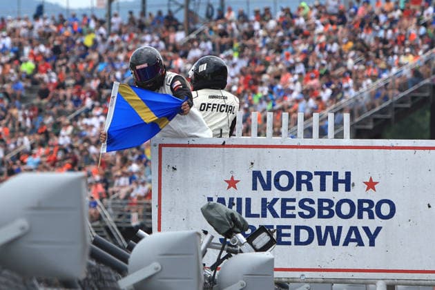 NORTH WILKESBORO, NC - JULY 18: A NASCAR, Motorsport, USA official shows the move over flag to a competitor during the running of the NASCAR Craftsman Truck Series FaithFest 250 on July 18, 2026 at North Wilkesboro Speedway in North Wilkesboro, NC. (Photo by Jeff Robinson Icon Sportswire) AUTO: JUL 18 NASCAR CRAFTSMAN Truck Series Faith Fest 250 EDITORIAL USE ONLY Icon26071825385250