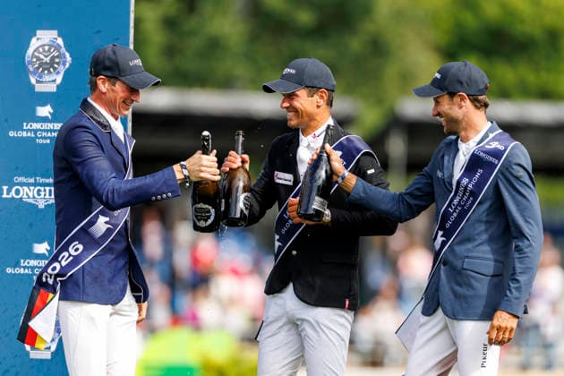 RIESENBECK - Longines Global Champions Tour of Riesenbeck 2026, RIESENBECK - Longines Global Champions Tour of Riesenbeck 2026 BETTENDORF Victor (LUX), DEUSSER Daniel (GER), KUKUK Christian (GER) Sektdusche Podest Siegerehrung Prize giving ceremony Longines GCT Grand Prix of Riesenbeck CSI5* - Int. jumping competition against the clock with jump-off (1.60 m) Riesenbeck, Riesenbeck International 19. July 2026 - *** RIESENBECK Longines Global Champions Tour of Riesenbeck 2026, RIESENBECK Longines Global Champions Tour of Riesenbeck 2026 BETTENDORF Victor LUX, DEUSSER Daniel GER, KUKUK Christian GER Sparkling wine shower Podium Prize-giving ceremony Longines GCT Grand Prix of Riesenbeck CSI5* International jumping competition against the clock with a jump-off 1 60 m Riesenbeck, Riesenbeck International July 19, 2026