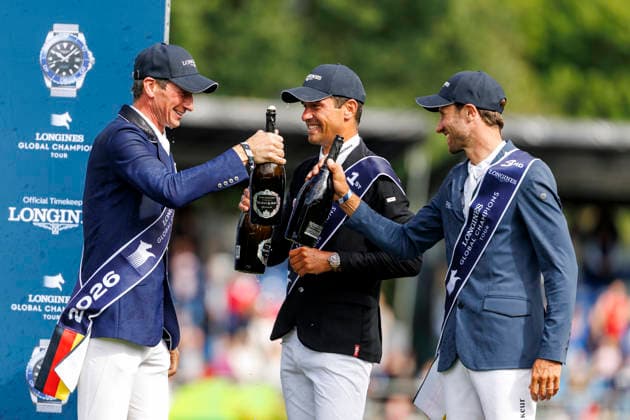 RIESENBECK - Longines Global Champions Tour of Riesenbeck 2026, RIESENBECK - Longines Global Champions Tour of Riesenbeck 2026 BETTENDORF Victor (LUX), DEUSSER Daniel (GER), KUKUK Christian (GER) Sektdusche Podest Siegerehrung Prize giving ceremony Longines GCT Grand Prix of Riesenbeck CSI5* - Int. jumping competition against the clock with jump-off (1.60 m) Riesenbeck, Riesenbeck International 19. July 2026 - *** RIESENBECK Longines Global Champions Tour of Riesenbeck 2026, RIESENBECK Longines Global Champions Tour of Riesenbeck 2026 BETTENDORF Victor LUX, DEUSSER Daniel GER, KUKUK Christian GER Sparkling wine shower Podium Prize-giving ceremony Longines GCT Grand Prix of Riesenbeck CSI5* International jumping competition against the clock with a jump-off 1 60 m Riesenbeck, Riesenbeck International July 19, 2026
