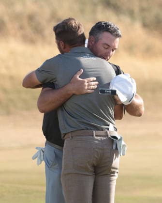 New Zealand s Ryan Fox embraces fellow golfer Sam Burns after his victory at the 154th Open Championship at Royal Birkdale in Southport, on Sunday, July 19, 2026. Cox won the tournament with a score of ten under par.  LON2026071909 HUGOxPHILPOTT