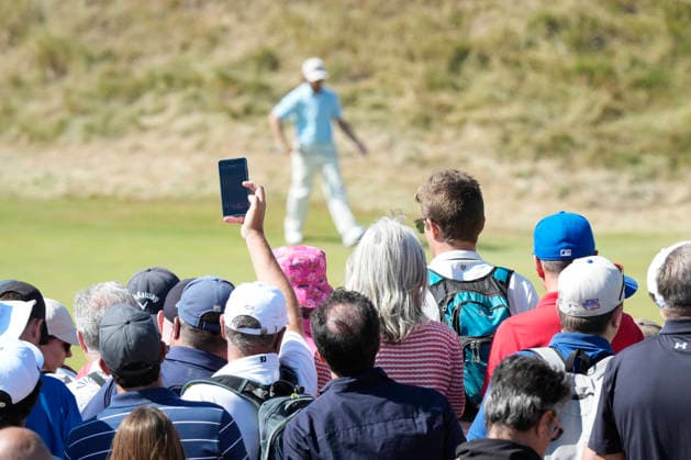 SOUTHPORT, ENGLAND - JULY 19: A fan takes a photo of Tommy Fleetwood (ENG) on the 10th green during Round 4 of the 154th Open Championship at the Royal Birkdale Golf Club, Southport on July 19, 2026 in Merseyside, England The 154th British Open Championship