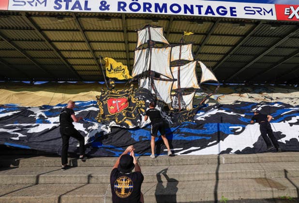 SÖLVESBORG, SWEDEN 20260721 Mjällby fans in the stands cheering ahead of Tuesday s football match, second qualifying round for the Champions League, first leg Mjällby AIF- Lincoln Red Imps FC, at Strandvallen in Sölvesborg, Sweden, 21 July 2026. SÖLVESBORG SWEDEN x10600x *** SÖLVESBORG, SWEDEN July 21, 2026 Mjällby fans in the stands cheering ahead of Tuesday’s soccer match—the second qualifying round of the Champions League, first leg between Mjällby AIF and Lincoln Red Imps FC—at Strandvallen in Sölvesborg, Sweden, July 21, 2026 SÖLVESBORG SWEDEN x10600x  Copyright: xAndreasxHillergren TTx CHAMPIONS LEAGUE QUALIFYING MJÄLLBY-LINCOLN RED IMPS