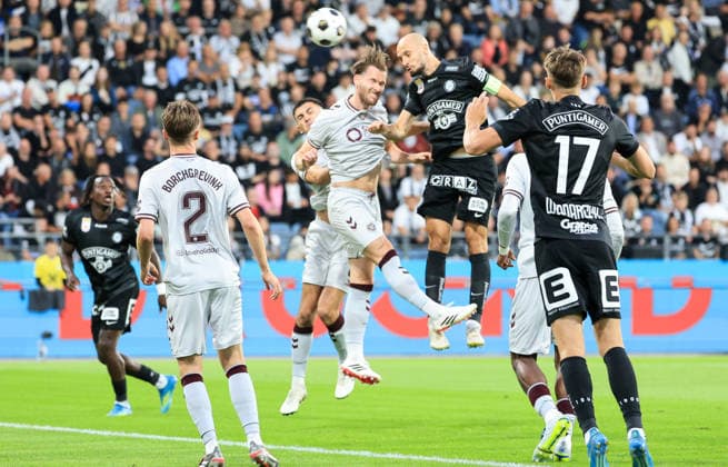 SOCCER - UEFA CL, Sturm vs Hearts GRAZ,AUSTRIA,21.JUL.26 - SOCCER - UEFA Champions League, qualification, SK Sturm Graz vs Heart of Midlothian FC. Image shows Christian Borchgrevink (Hearts) and Jon Gorenc-Stankovic (Sturm).  GEPAxpictures xWolfgangxGrebien