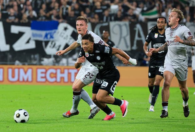 SOCCER - UEFA CL, Sturm vs Hearts GRAZ,AUSTRIA,21.JUL.26 - SOCCER - UEFA Champions League, qualification, SK Sturm Graz vs Heart of Midlothian FC. Image shows Christian Borchgrevink (Hearts), Jacob Peter Hoedl (Sturm) and Calvin Miller (Hearts).  GEPAxpictures xWolfgangxGrebien