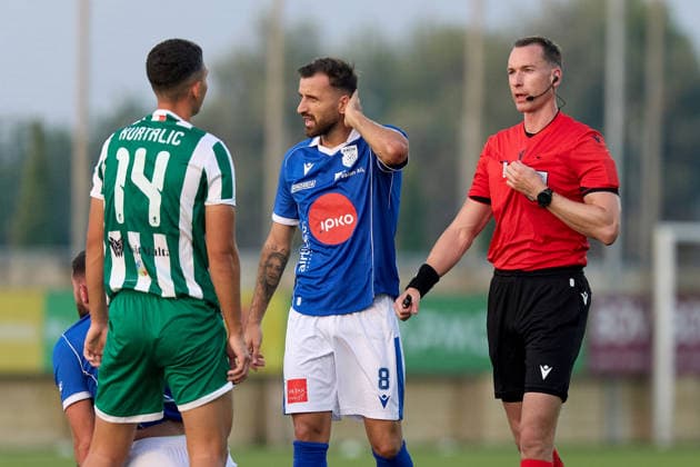 UEFA‘appointed match referee Marius Hansen Grotta (right) gestures during the UEFA Conference League Second qualifying round, first‘leg match between Floriana and Drita at Centenary Stadium, Ta™ Qali, Malta, on 21 July 2026. Floriana v Drita - UEFA Conference League Second Qualifying Round 1st Leg