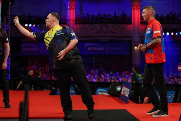 RECORD DATE NOT STATED 21st July 2026, Winter Gardens, Blackpool, Lancashire, England; 2026 Betfred World Matchplay Darts, Day Four; Luke Littler in action at the oche as Nathan Aspinall looks on AidanxHunter