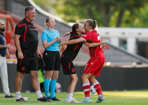 Wrexham, Wales, 22nd July 2026. Lili Jones of Wrexham celebrates scoring their sides second goal with Jenny Sugarman manager of Wrexham during the Pyunik v Wrexham Women UEFA Womens Champions League Qualifying match at The Racecourse, Wrexham. Picture credit should read: Cody Froggatt Sportimage EDITORIAL USE ONLY. No use with unauthorised audio, video, data, fixture lists, club league logos or live services. Online in-match use limited to 120 images, no video emulation. No use in betting, games or single club league player publications. SPI_020_CF_PYUNIK_V_WREXHAM_WOMEN SPI-4881-0020