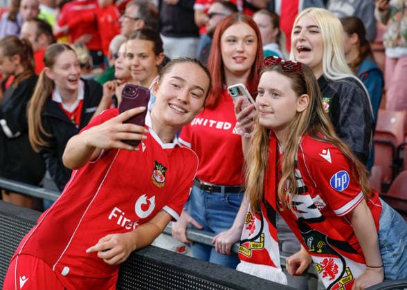 Wrexham, Wales, 22nd July 2026. Faye Hillier-Knox of Wrexham takes a selfie with a fan following the Pyunik v Wrexham Women UEFA Womens Champions League Qualifying match at The Racecourse, Wrexham. Picture credit should read: Cody Froggatt Sportimage EDITORIAL USE ONLY. No use with unauthorised audio, video, data, fixture lists, club league logos or live services. Online in-match use limited to 120 images, no video emulation. No use in betting, games or single club league player publications. SPI_035_CF_PYUNIK_V_WREXHAM_WOMEN SPI-4881-0035