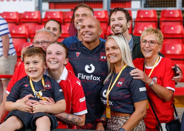 Wrexham, Wales, 22nd July 2026. Mikayla Cook of Wrexham celebrates the full time result with her family and friends following the Pyunik v Wrexham Women UEFA Womens Champions League Qualifying match at The Racecourse, Wrexham. Picture credit should read: Cody Froggatt Sportimage EDITORIAL USE ONLY. No use with unauthorised audio, video, data, fixture lists, club league logos or live services. Online in-match use limited to 120 images, no video emulation. No use in betting, games or single club league player publications. SPI_036_CF_PYUNIK_V_WREXHAM_WOMEN SPI-4881-0036