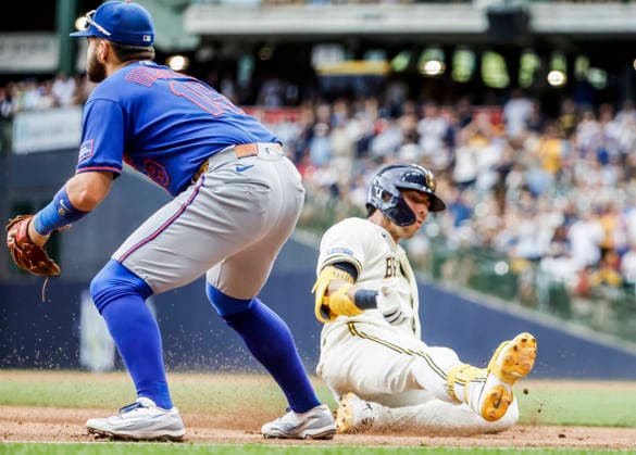 Milwaukee Brewers designated hitter Christian Yelich (R) slides into third base behind New York Mets third baseman Bo Bichette (L) after hitting an RBI triple in the sixth inning of the MLB, Baseball Herren, USA game between the New York Mets and the Milwaukee Brewers at American Family Field in Milwaukee, Wisconsin on Wednesday July 22, 2026.  MIL2026078 TANNENxMAURY